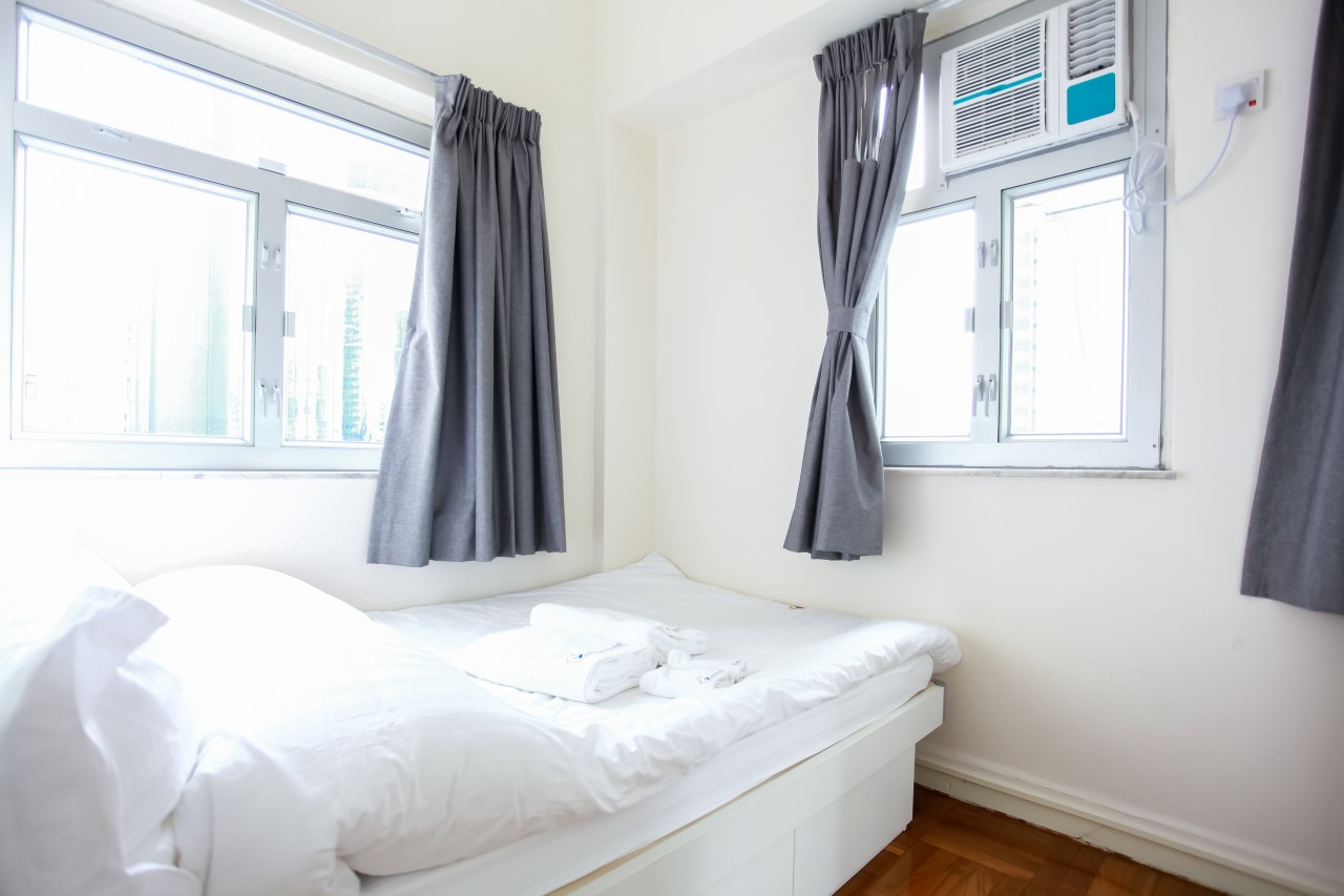 Double bed facing window in Fortress Hill 2 bedrooms serviced apartment