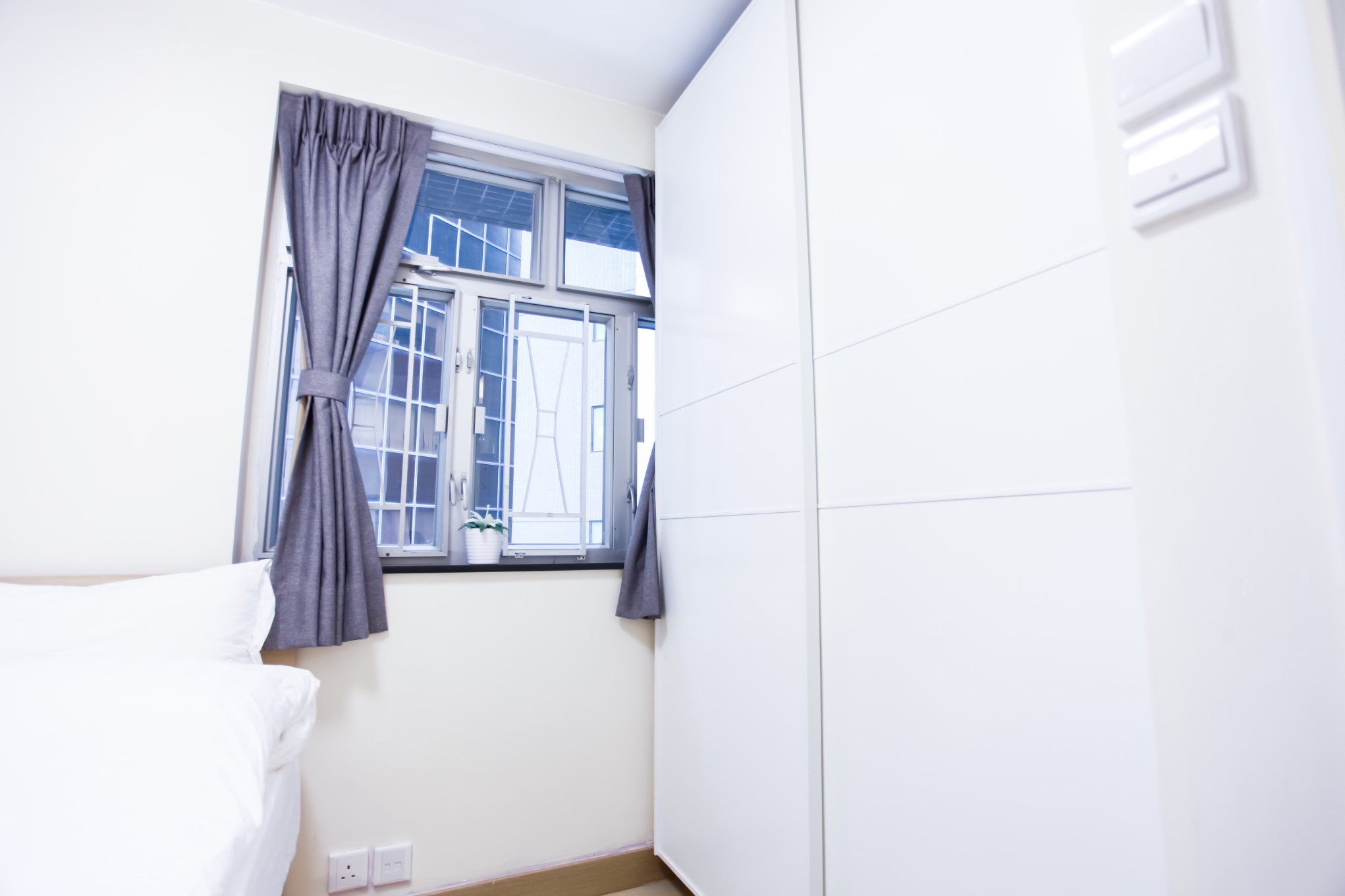 Queen size bed with white wardrobe combination in Fortress Hill 2 BR apartment