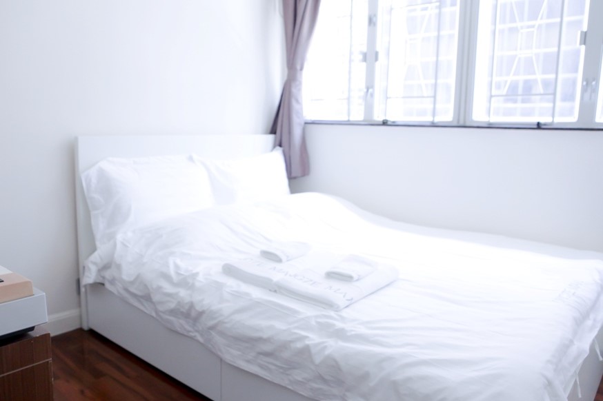 Queen size bed facing window in Fortress Hill 2 bedrooms serviced Apartment Hong Kong