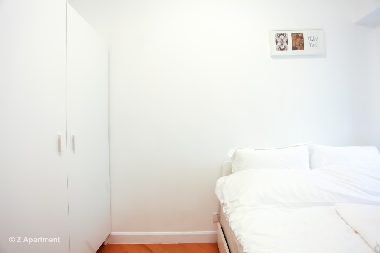 Queen size bed with white wardrobe combination in Tseung Kwan O 2 BR serviced apartment Hong Kong