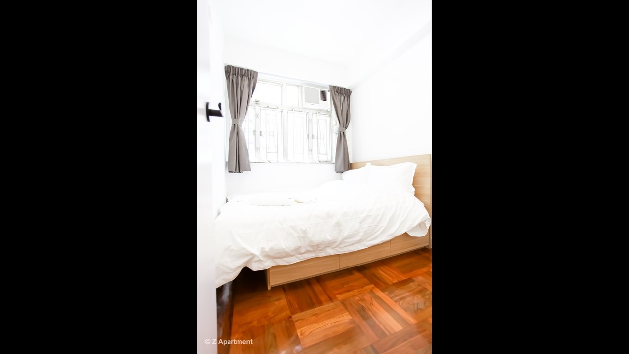 Queen size bed with white wardrobe combination in Fortress Hill 2 BR serviced apartment Hong Kong