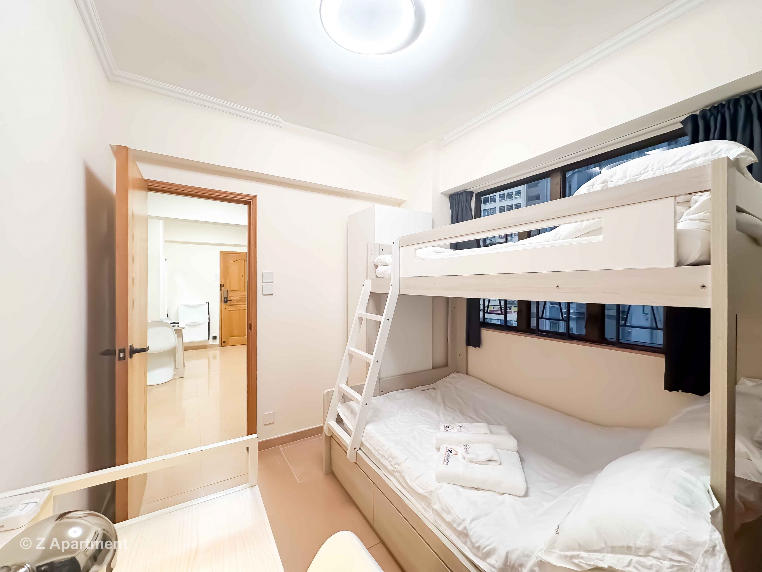 Bunk bed facing window with white wardrobe, working desk in Tin Hau 2 bedrooms serviced Apartment Hong Kong